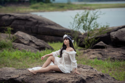 Woman sitting on rock