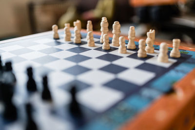 Chess piece set on the chessboard. focus on the white side.