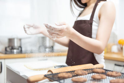 Midsection of woman preparing food at home