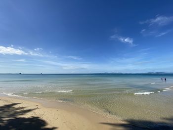 Scenic view of beach against blue sky