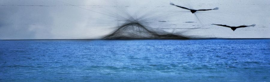 Scenic view of sea against blue sky