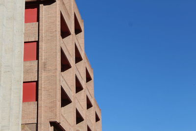 Low angle view of building against clear blue sky