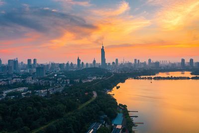 Aerial view of buildings in city during sunset