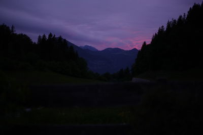 Scenic view of silhouette mountains against sky at sunset