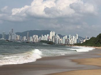 Scenic view of sea and buildings against sky