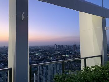 Modern buildings against sky during sunset