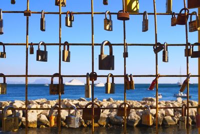 Clothes hanging by sea against sky