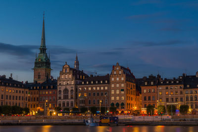 Illuminated buildings in city at dusk