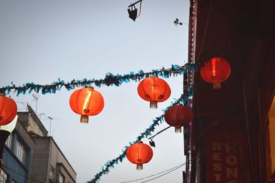 Low angle view of red lanterns hanging on wall
