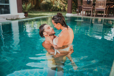 Couple standing in swimming pool