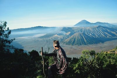 Man standing by mountains against sky