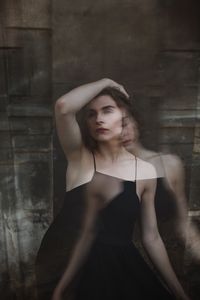 Blurred motion of woman against wall