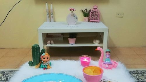 Woman with toy on table at home