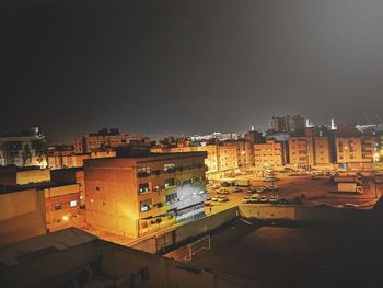 High angle view of illuminated buildings against sky at night