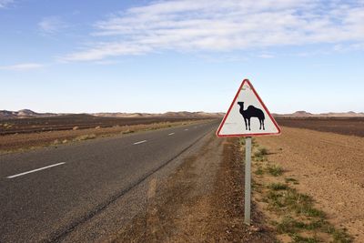 Road sign against clear sky