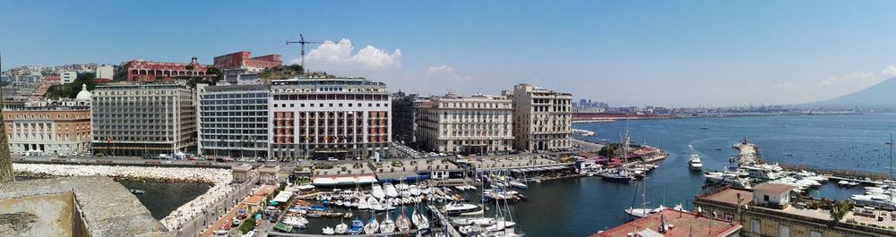 Panoramic view of buildings and sea against sky