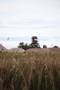 Traditional windmill on field against sky