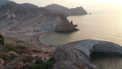 Scenic view of sea and mountains against sky