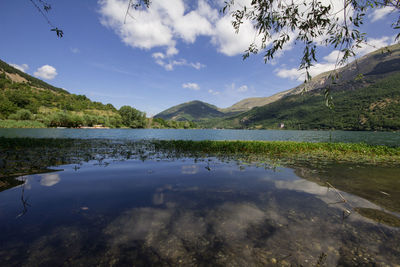 Scenic view of lake and mountains against sky