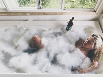 Full length of woman in bathtub at home