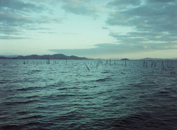 Scenic view of sea against cloudy sky