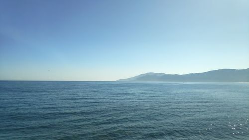 Scenic view of sea against clear blue sky