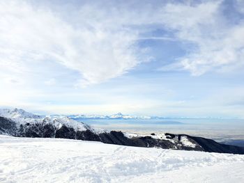 Scenic view of snowcapped mountains against sky