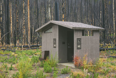 Restroom with burned trees in a campground