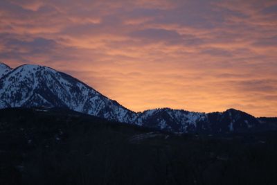 Scenic view of snowcapped mountains against sky during sunset