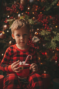 Portrait of cute girl playing with christmas tree