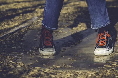 Low section of people standing on tiled floor