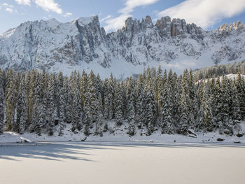 Karersee in autumn with early snow in dolomites italy