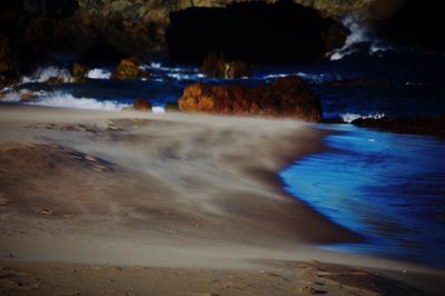 Waves splashing on rocks at beach