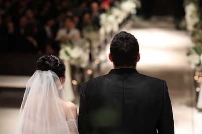 Rear view of wedding couple standing in church