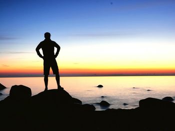 Silhouette of man by the sea