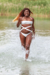 Portrait of a beautiful young woman in water