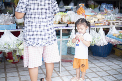 Rear view of couple standing in market