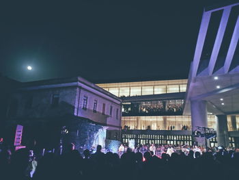 Group of people in front of building at night