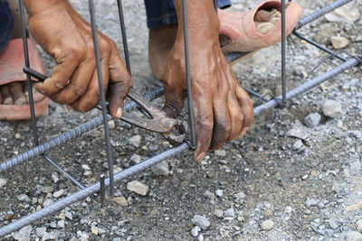 Low section of person working on metal