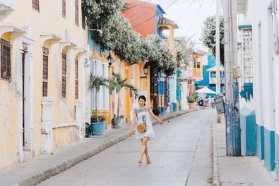 Woman walking on street in city