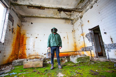 Full length of man standing in abandoned building