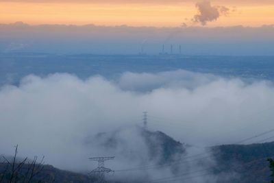 Smoke emitting from chimney against sky during sunset