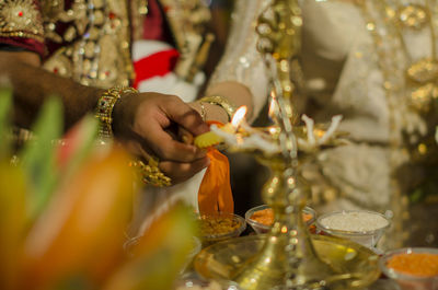 Light oil lamp by wedding couple 