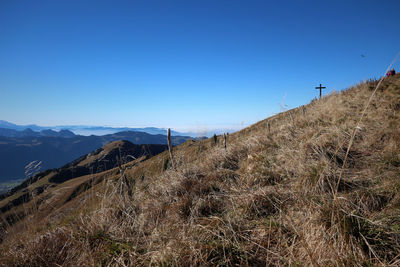 Scenic view of mountains against clear blue sky