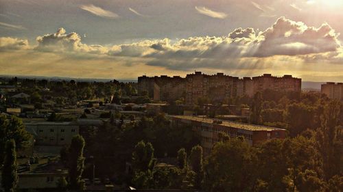 Buildings against cloudy sky