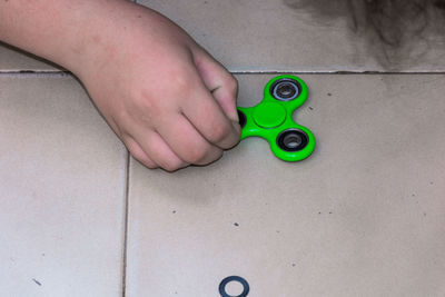 Low section of boy playing with toy