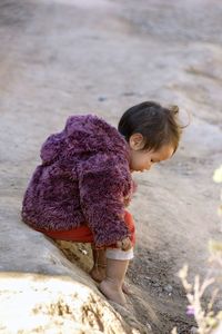 Baby hmong playing on dirty ground in chiang mai thailand