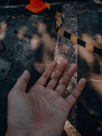 Close-up of hand holding cigarette