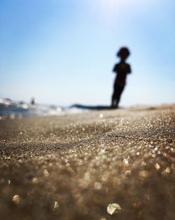 Man on beach against clear sky