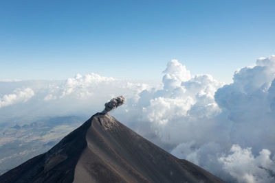 Low angle view of volcanic mountain against sky